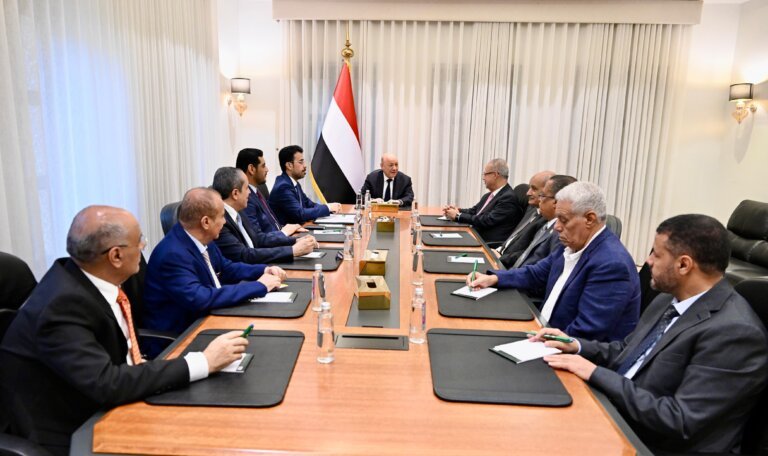 Yemeni officials seated around a conference table during a government meeting chaired by Rashad al-Alimi