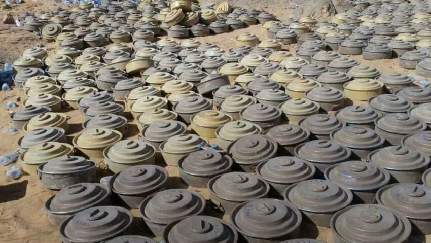 Rows of recovered anti-tank mines laid out on open ground after clearance operations in Yemen