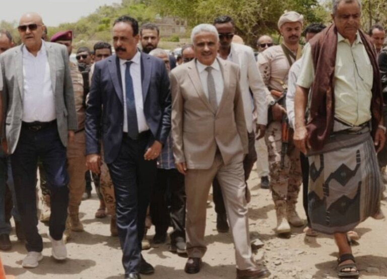 Yemeni officials walking at the launch of the Nashmah-Hawban Qadas road rehabilitation project in Taiz