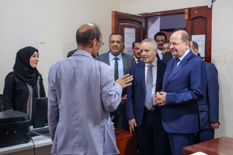Yemeni Prime Minister Shaya al-Zindani touring an office at the Ministry of Social Affairs and Labour in Aden with officials and staff