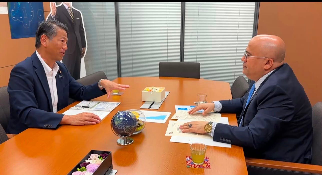 Yemen's Ambassador to Japan Adel al-Sunaini meeting Japanese State Minister of Economy, Trade and Industry Kenji Yamada across a table in Tokyo