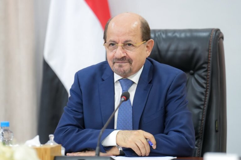 Yemeni Prime Minister Shaya Zindani sits at his desk before the national flag during a video call with Britain's Middle East minister.