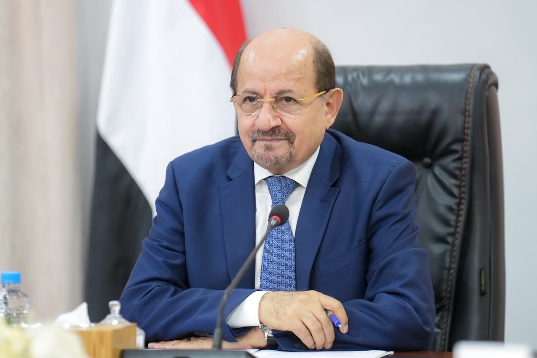 Yemeni Prime Minister Shaya Zindani sits at his desk before the national flag during a video call with Britain's Middle East minister.