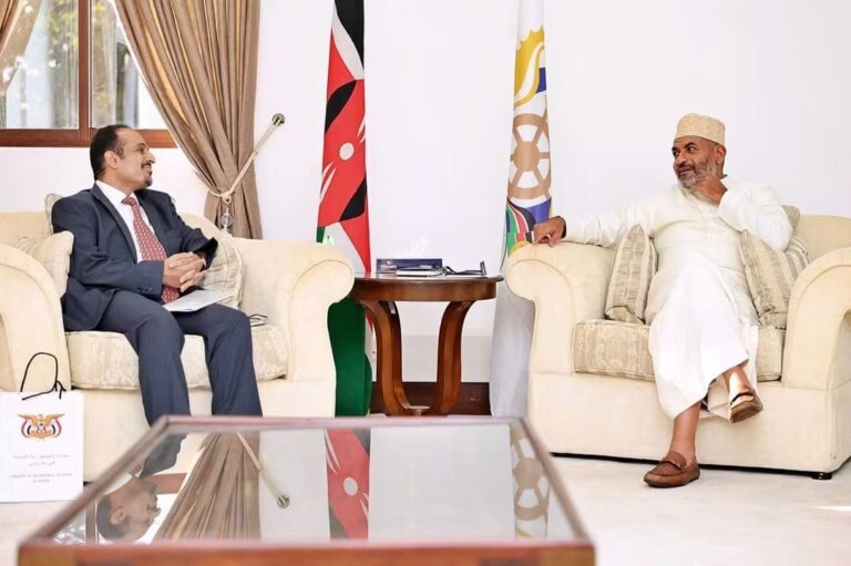 Yemen's acting chargé d'affaires Abdul Salam al-Awadhi seated with Mombasa Governor Abdullswamad Sherrif Nassir during talks, Kenyan and Mombasa County flags behind them