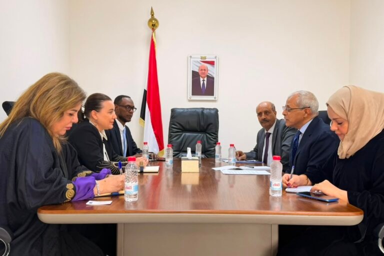 Yemen's vice foreign minister and the UNDP resident representative seated with their delegations at a meeting table in Aden