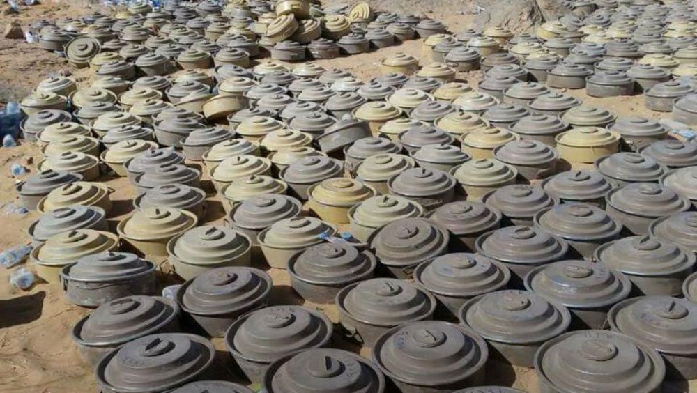 Landmines and unexploded ordnance laid out in rows after clearance by Masam teams in Yemen