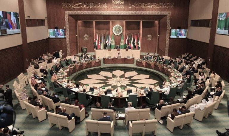 Delegates seated around the horseshoe table in the Arab League Council chamber in Cairo