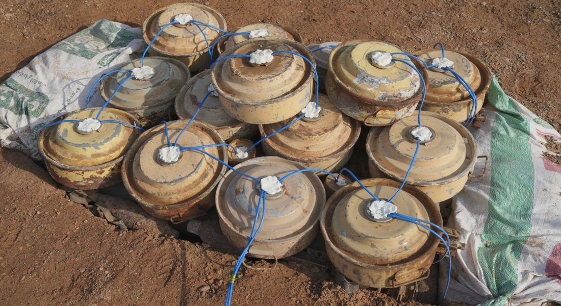 Anti-tank landmines stacked in the ground after clearance by a demining team in Yemen