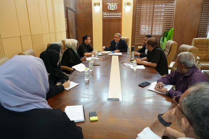 Yemeni health ministry officials and International Committee of the Red Cross representatives seated around a meeting table in Aden