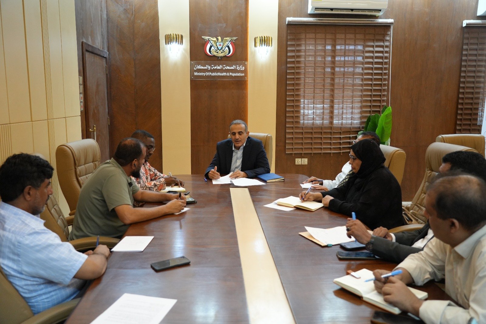 Yemen’s health minister Qasim Buhaibeh seated at a conference table with officials during a meeting in Aden