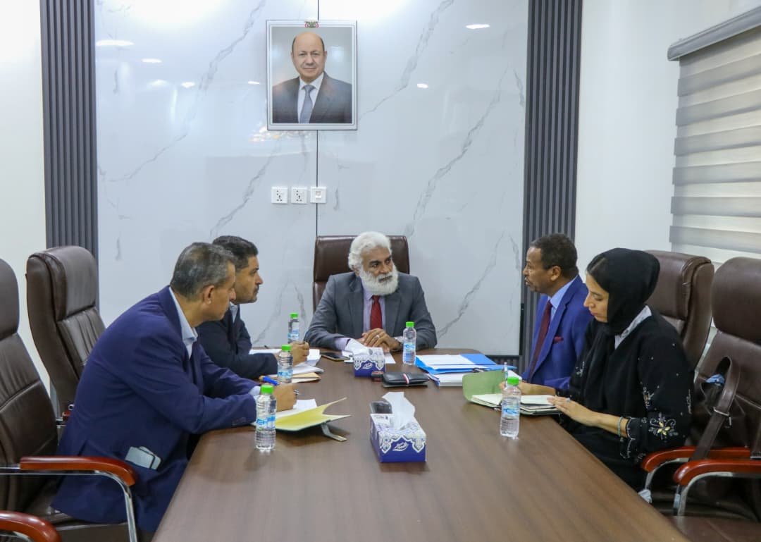 Officials seated around a conference table during a meeting with United Nations agency representatives in Aden