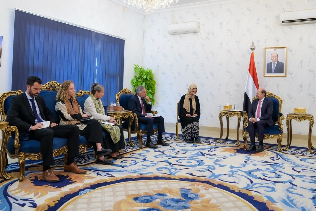 Officials and diplomats seated in a government reception room in Aden during a meeting
