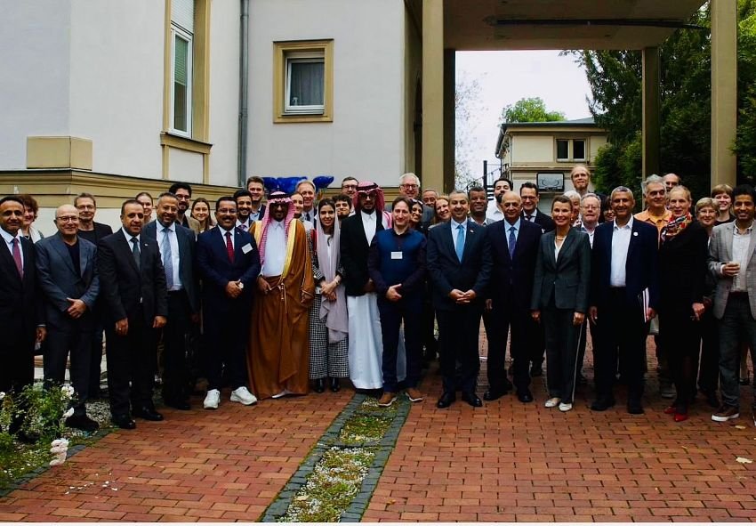 Delegates to the Yemeni-German cooperation conference stand for a group photograph outside the venue in Berlin