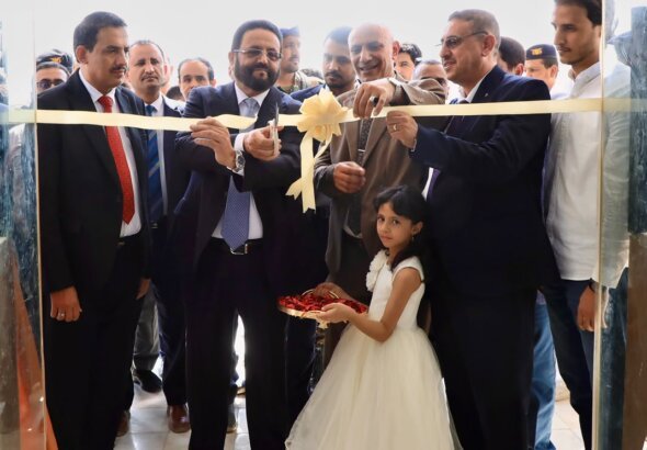 Officials cut a ribbon at the opening of the College of Information Technology and Computer Science building at the University of Saba Region in Marib