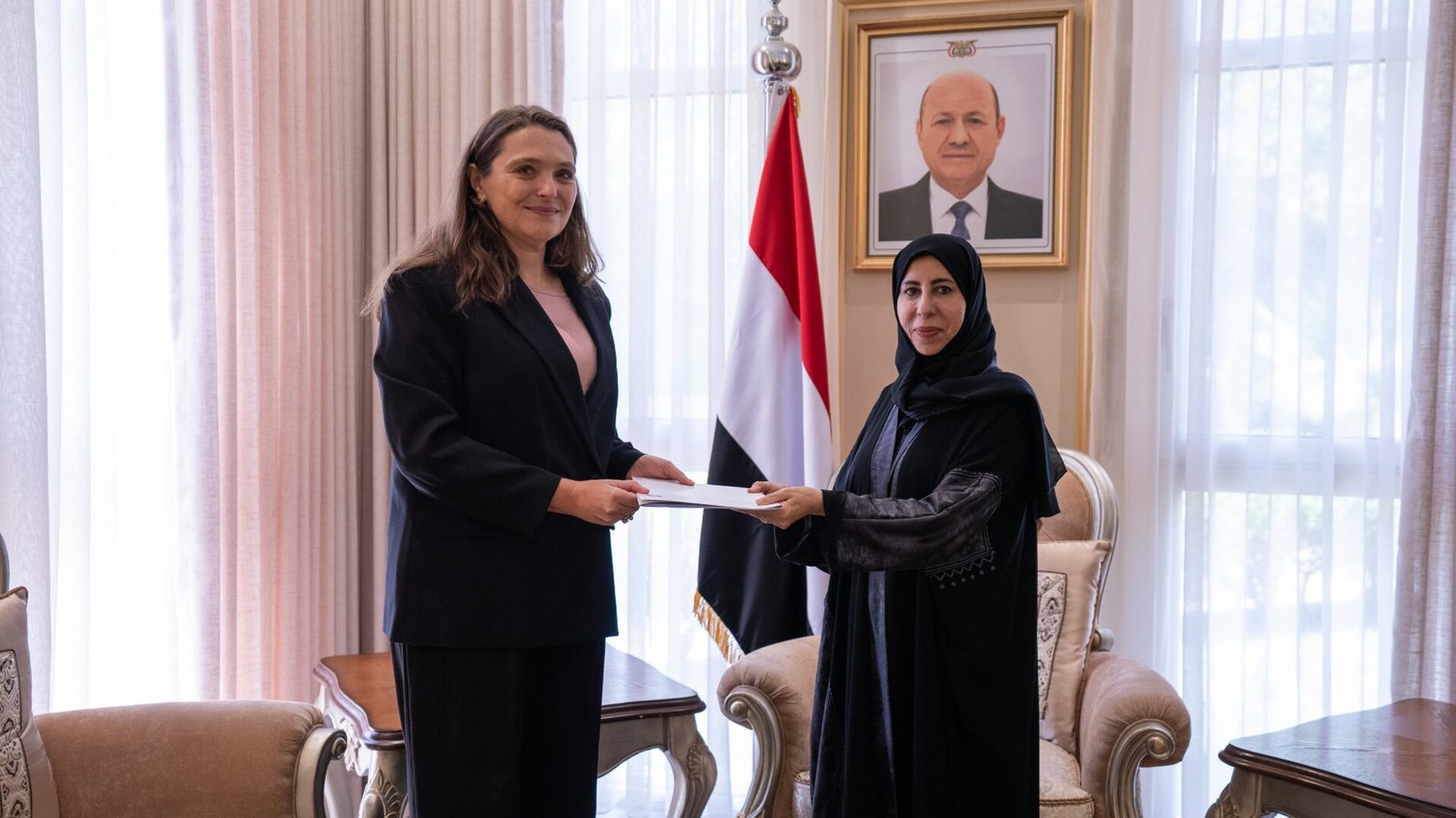 Denmark's non-resident ambassador to Yemen, Merete Juhl, hands a copy of her credentials to Yemeni Foreign Minister Afrah al-Zouba in Riyadh