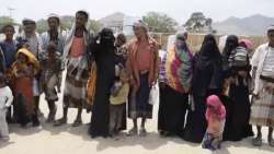 Displaced Yemeni families gather with their belongings after fleeing fighting in western Taiz province