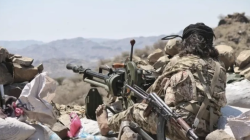 Yemeni government fighters man a machine gun position on a mountain front line in al-Dhalea province