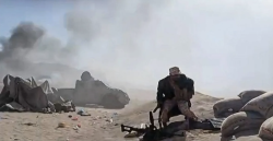 Smoke rising over open ground during fighting in western Yemen