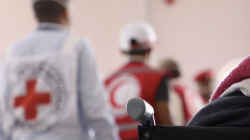 Red Cross and Red Crescent staff in marked vests working at a site in Yemen