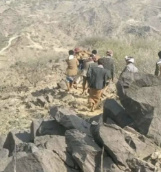 Residents search rocky ground above a collapsed gold mine in Aflah al-Sham district, Hajjah governorate, Yemen