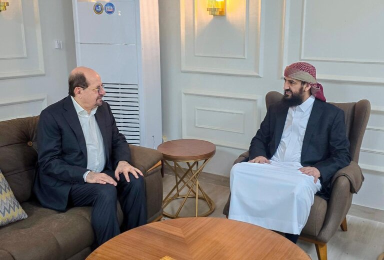 Two Yemeni officials seated in armchairs during a meeting in Aden