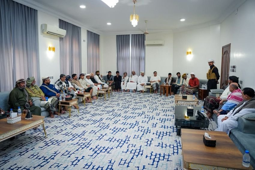 Officials, dignitaries and community leaders seated around a reception hall in Mukalla during a meeting chaired by Presidential Leadership Council member Salem al-Khanbashi