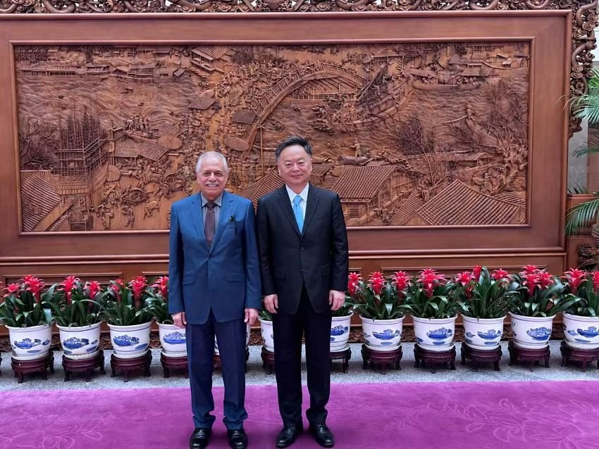 Yemen ambassador Mohammed al-Maytami stands with a Chinese foreign ministry official in a Beijing reception hall