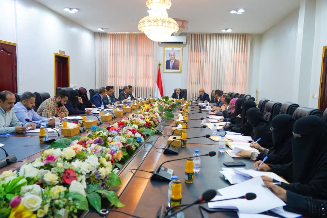 Officials and organisation representatives seated around a long conference table at a government meeting in Aden, Yemen