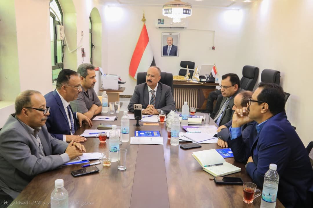 Yemeni transport minister Mohsen al-Omari chairs a committee meeting with officials seated around a conference table in Aden