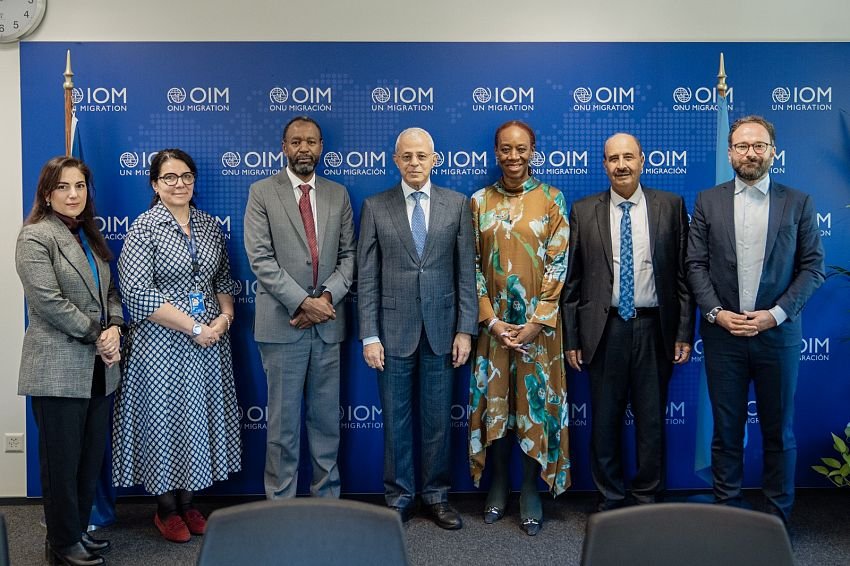 Officials pose for a group photograph at an international meeting