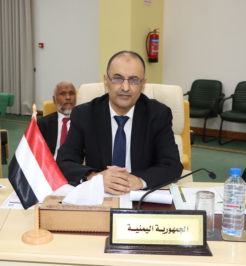 A Yemeni delegate seated behind a Republic of Yemen nameplate at an Arab conference table