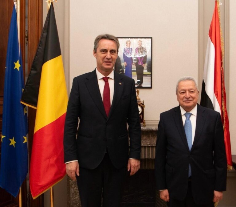 Yemen's ambassador to Belgium, right, stands with Belgian Senate President Vincent Blondel beside Belgian and European Union flags in Brussels.