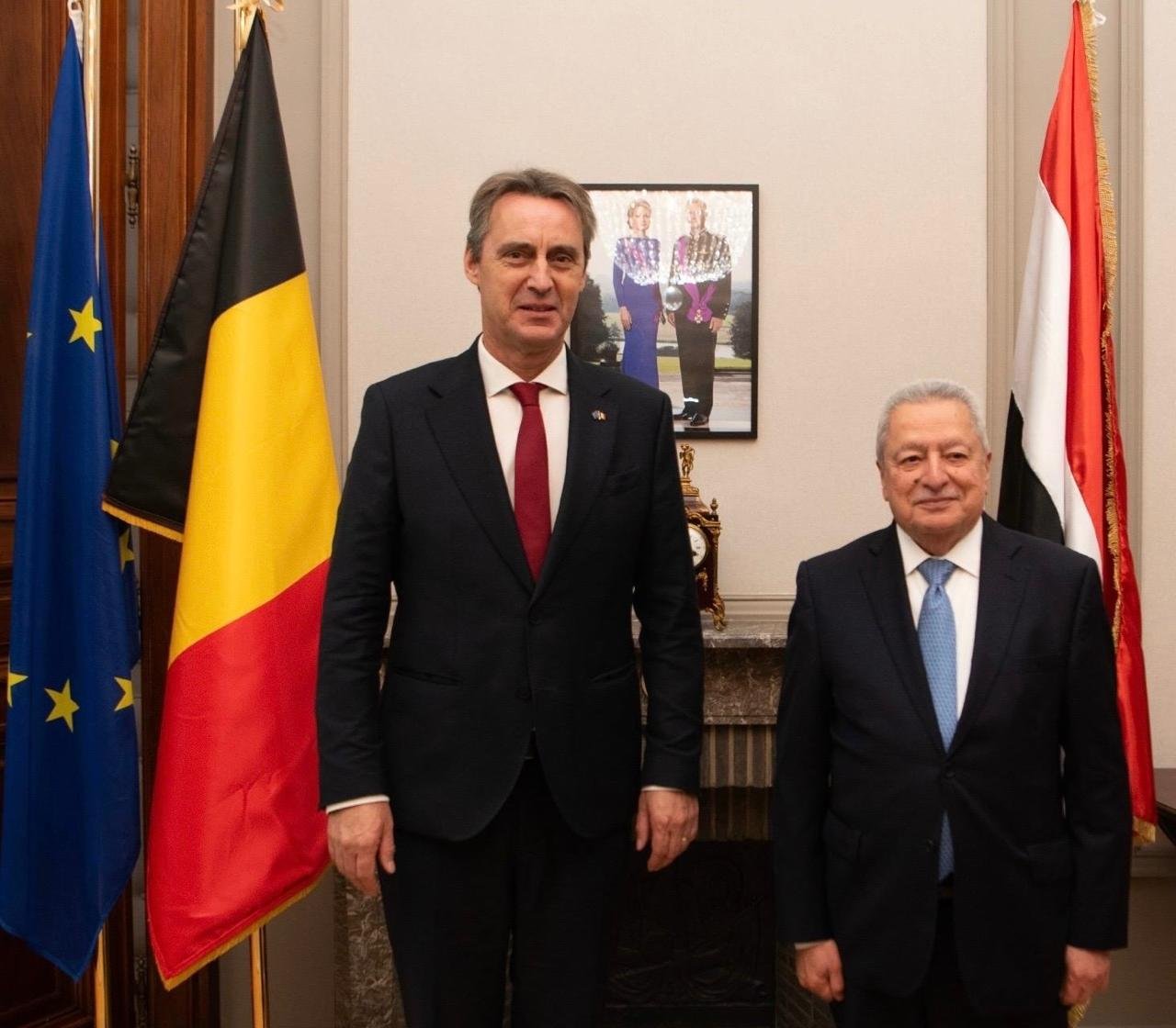 Yemen's ambassador to Belgium, right, stands with Belgian Senate President Vincent Blondel beside Belgian and European Union flags in Brussels.