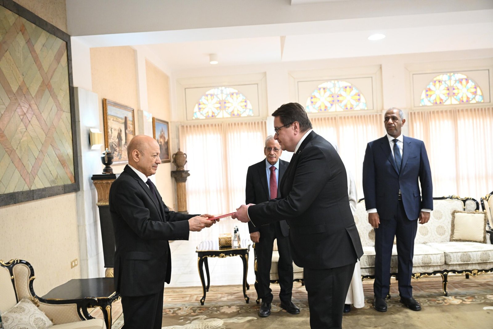President Rashad al-Alimi receives a credentials folder from a newly appointed ambassador at a ceremony in Riyadh