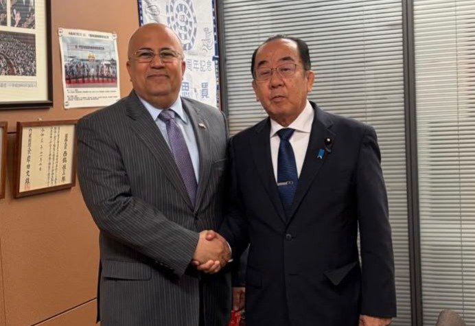 Yemen's ambassador to Japan Adel al-Sunaini shakes hands with Japanese lawmaker Kosaburo Nishime in a Tokyo office