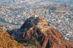 View of Taiz city in the Yemeni highlands with the hilltop Cairo Castle above the dense urban sprawl
