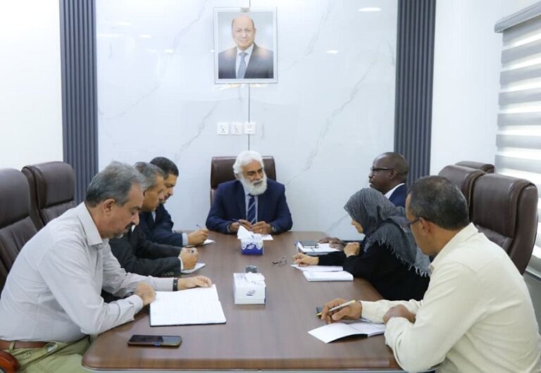 Yemeni planning ministry officials and UN refugee agency staff seated around a meeting table in Aden