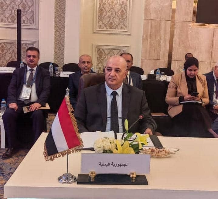 Yemeni officials seated at a conference table with the national flag during an Arab ministerial water session in Cairo