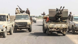 Armed fighters on pickup trucks mounted with heavy weapons on a road in Taiz governorate, Yemen