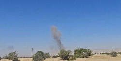 Smoke rises over open ground after a reported airstrike in Yemen