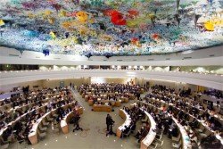 Delegates seated in the UN Human Rights Council chamber in Geneva beneath its coloured domed ceiling
