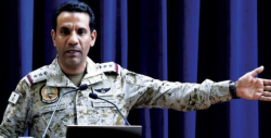 Saudi-led coalition spokesman Turki al-Maliki speaks at a podium during a military briefing